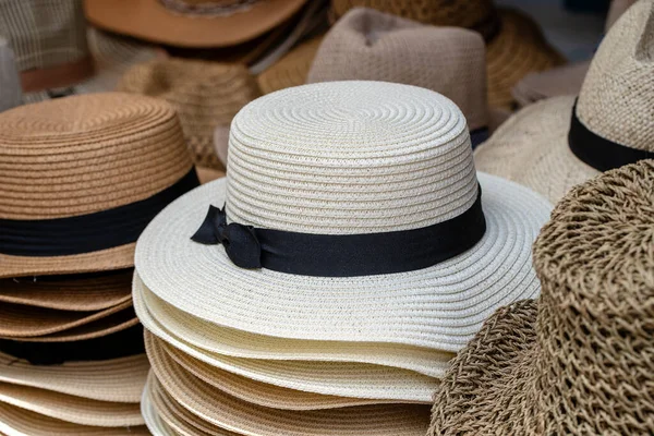 Straw hats on display for sale to tourists on street local market in Ubud, island Bali, Indonesia, close up