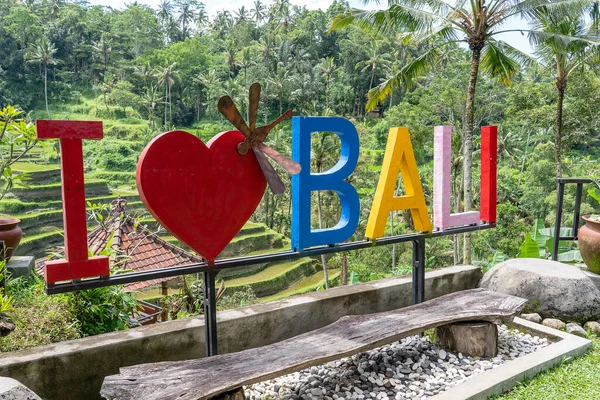 Colorful sign I Love Bali near rice fields terraces in the background. Island Bali, Indonesia . Close up