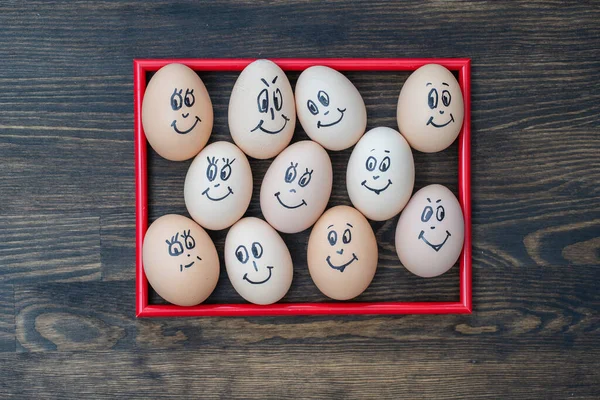 Picture Red Frame Many Funny Eggs Smiling Dark Wooden Wall — Stock Photo, Image