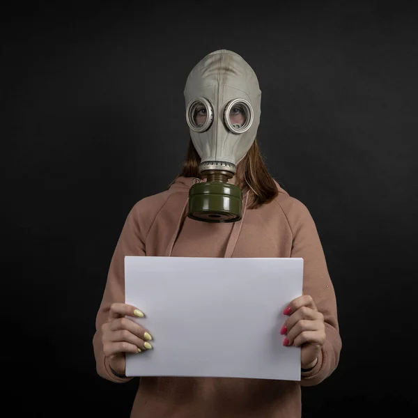 Girl Gas Mask Black Background Holds White Sheet Close Your — Stock Photo, Image