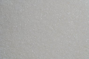 Beyaz granüllü şeker arka planda, üst manzara, yakın çekim. Sağlıksız yeme, obezite, kalp hastalığı, diyabet kavramı.