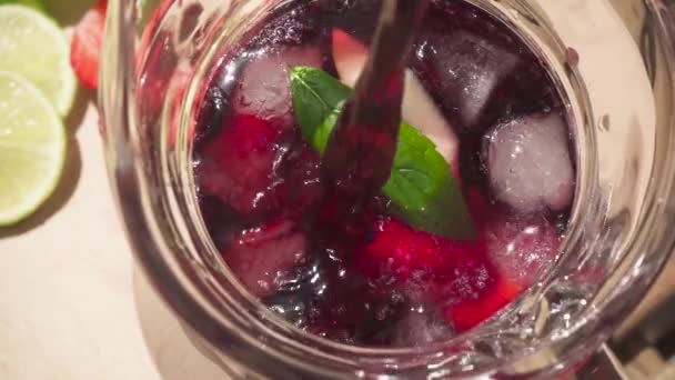 Movimento lento em uma garrafa com gelo e frutas para derramar vinho — Vídeo de Stock