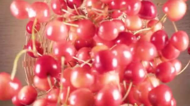 Slow motion cherry falls down into a wicker basket — Stock Video