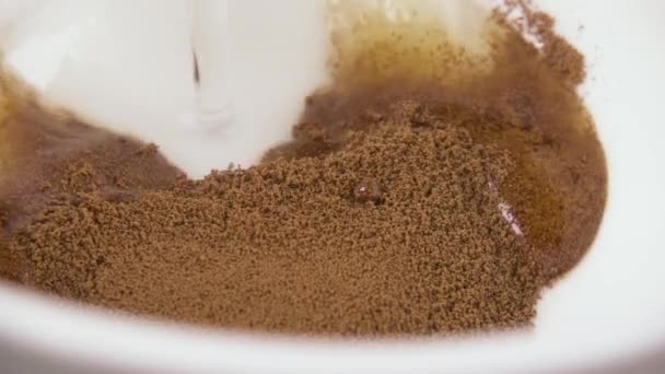 Slow motion water giet in een kopje koffie poeder — Stockvideo