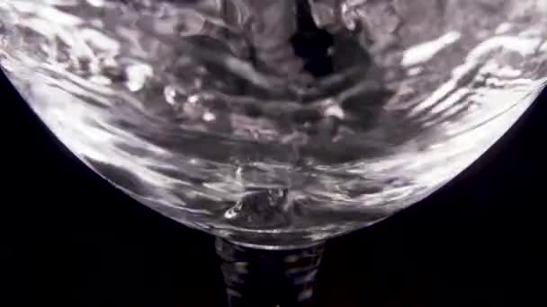 Slow motion transparant water giet in een transparant glas — Stockvideo