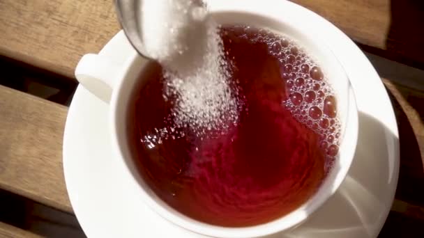 White porcelain cup on a saucer on a wooden table with a hot drink slow motion — Stock Video