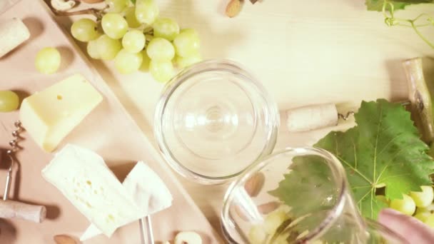 A glass of wine and a snack of cheese and chocolate — Stock Video