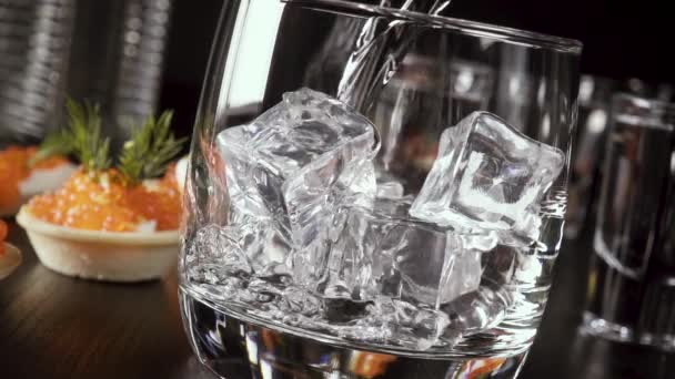 Slow motion a glass of vodka on the table with a snack — Stock Footage Slow motion a glass of vodka on the table with a snack Stock Video
