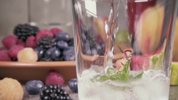 Zeitlupe reines Wasser mit Eis auf dem Hintergrund von Beeren — Stockvideo