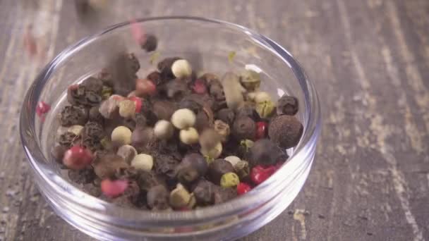 Slow motion a mixture peas of pepper falling into a bowl close-up — Stock Video