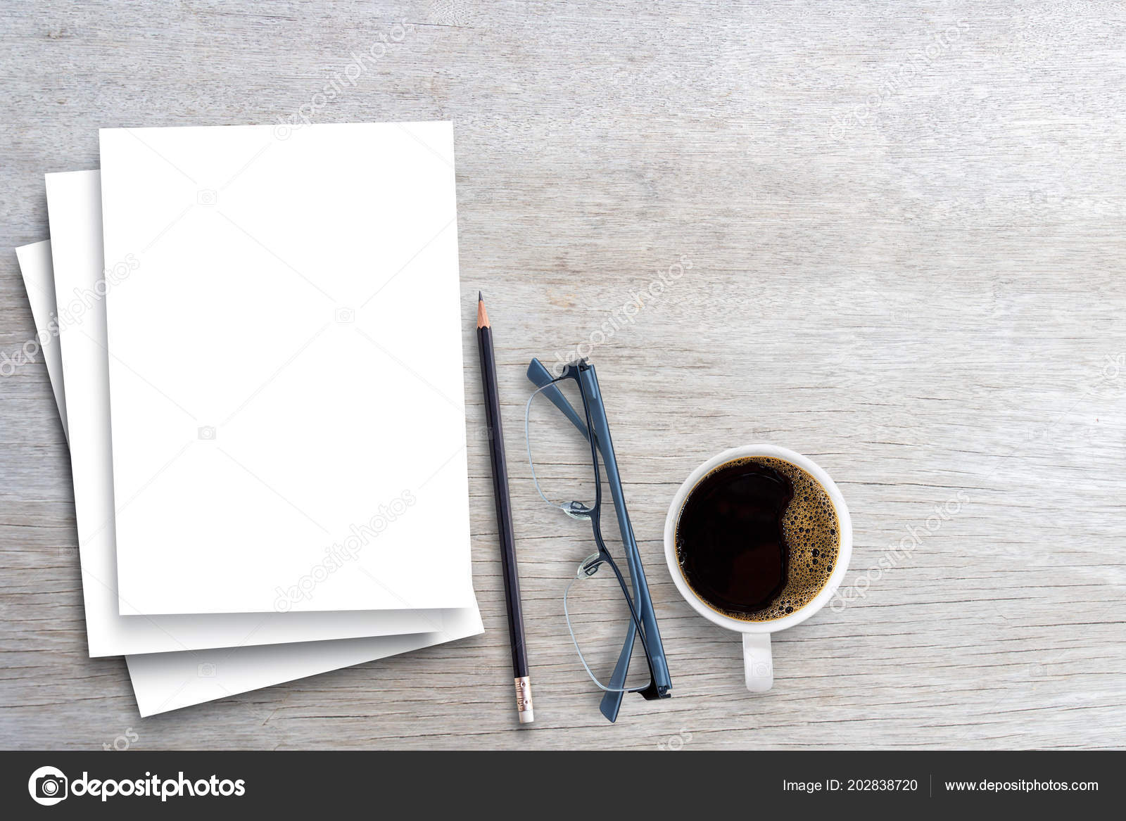 Top view of working table with blank paper notebook, cup of coffee and  eyeglasess., Stock image
