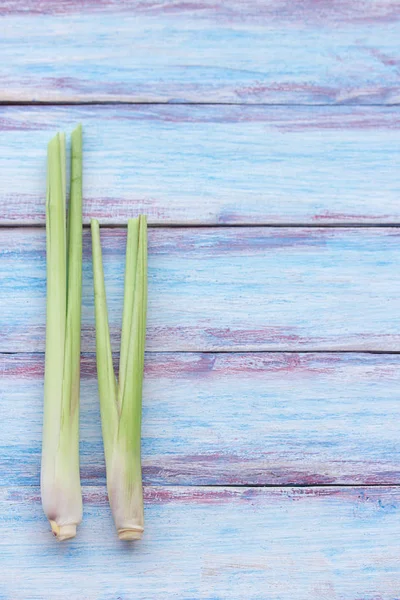 Close up fresh organic lemongrass no chemicals on wood table background.Fresh stems of lemongrass on a wooden surface.Winds in the intestines make appetite, asthma, brainstorming helps to concentrate.