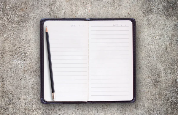 Blank notebooks and pencil on the cement floor. — Stock Photo, Image