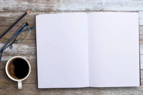 Top view with blank notebook or note pad and cup of coffee,glass — Stock Photo, Image