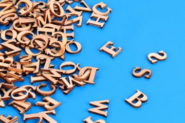 a heap of wooden letters are lying in the blue studio clipart