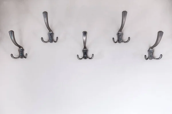 Five Metal Hangers Hooks White Wall — Stock Photo, Image