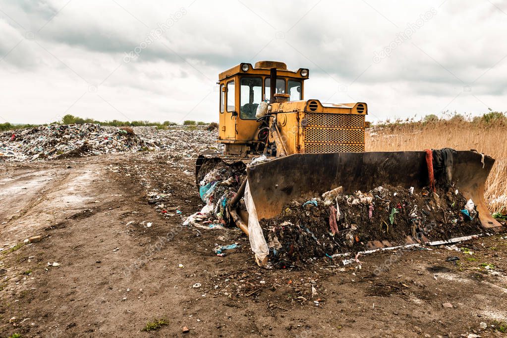 bulldozer on garbage dump