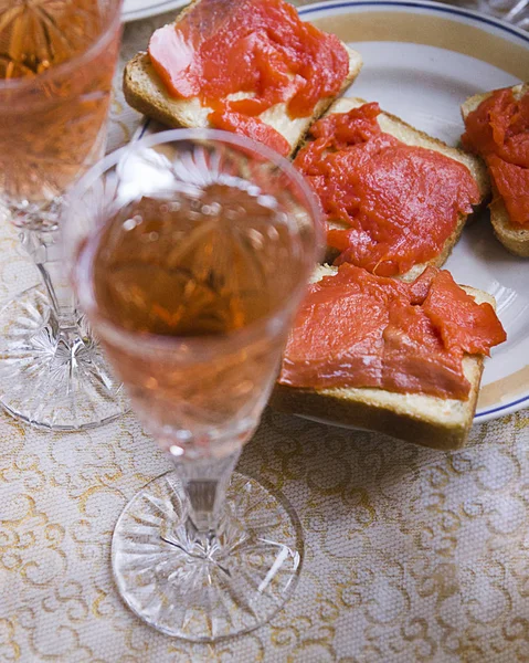 Sandwich with red fish and a glass of wine