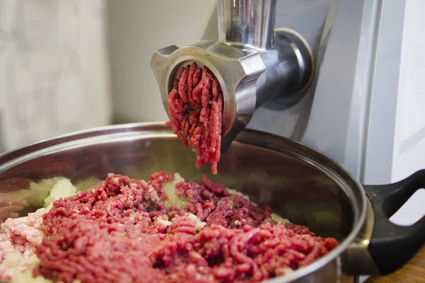Electric meat grinder grinds meat, minced meat