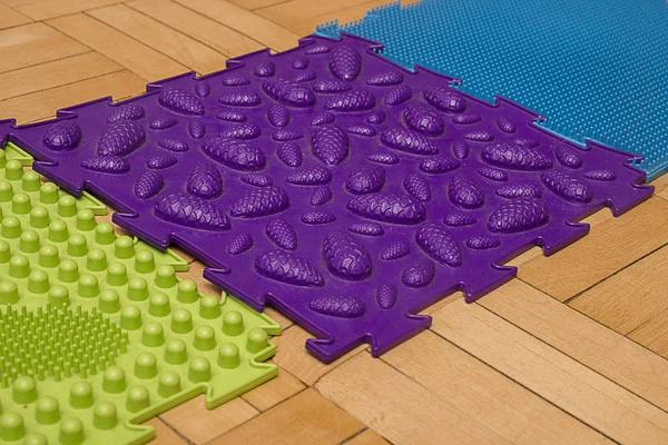 Massage pad for the feet. Purple rug with knobs