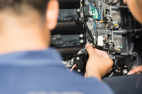 Boat mechanic is repairing the engine of the ship, Ship engine equipment.