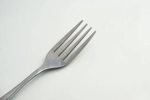 Dining Fork närbild ligger på vit bakgrund, bestick stål gaffel närbild — Stockfoto