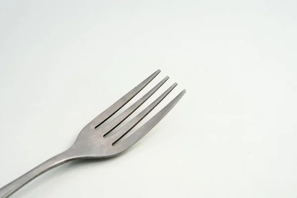 Dining fork closeup lies on white background, Cutlery steel fork close up — Stock Photo, Image