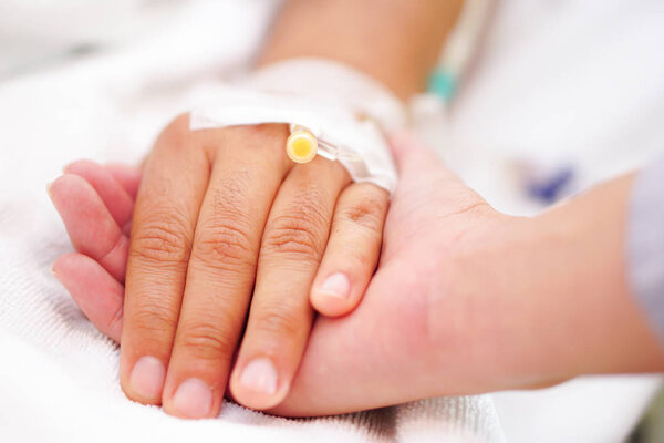 Hand sick with saline salt water line asian patient on bed in nursing hospital ward : healthy strong medical concept 