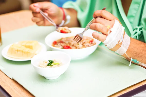 Asian senior or elderly old lady woman patient eating breakfast healthy food with hope and happy while sitting and hungry on bed in hospital.