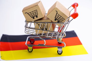 Alışveriş sepeti logosu ve Almanya bayrağı ile Kutu : İthalat İhracat Alışveriş online veya e-ticaret teslimat hizmeti mağaza ürün nakliye, ticaret, tedarikçi kavramı.