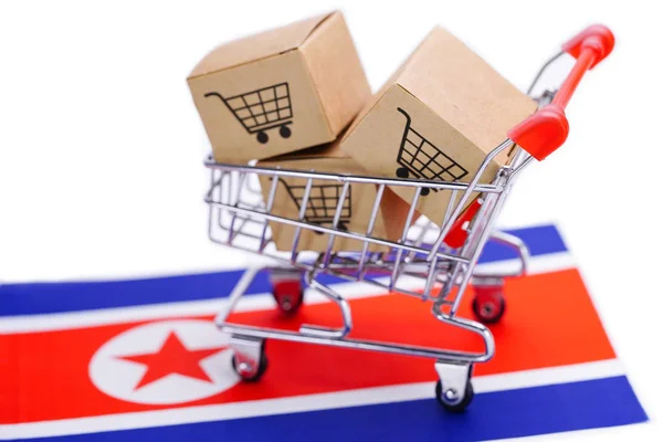 Box with shopping cart logo and North Korea flag : Import Export Shopping online or eCommerce delivery service store product shipping, trade, supplier concept