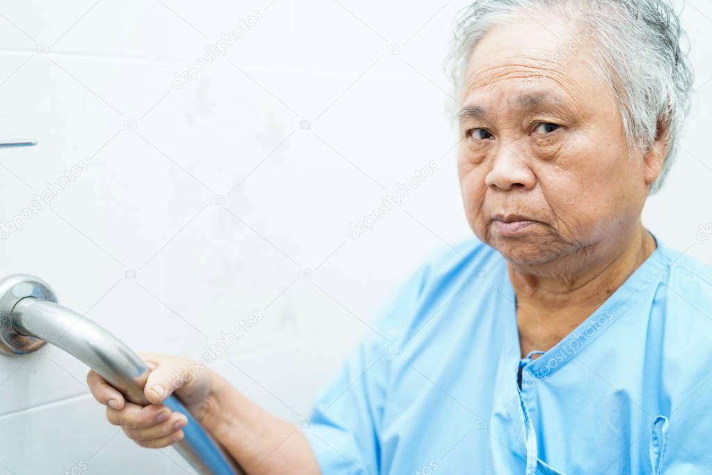Asian senior or elderly old lady woman patient use toilet bathroom handle security in nursing hospital ward : healthy strong medical concept. 