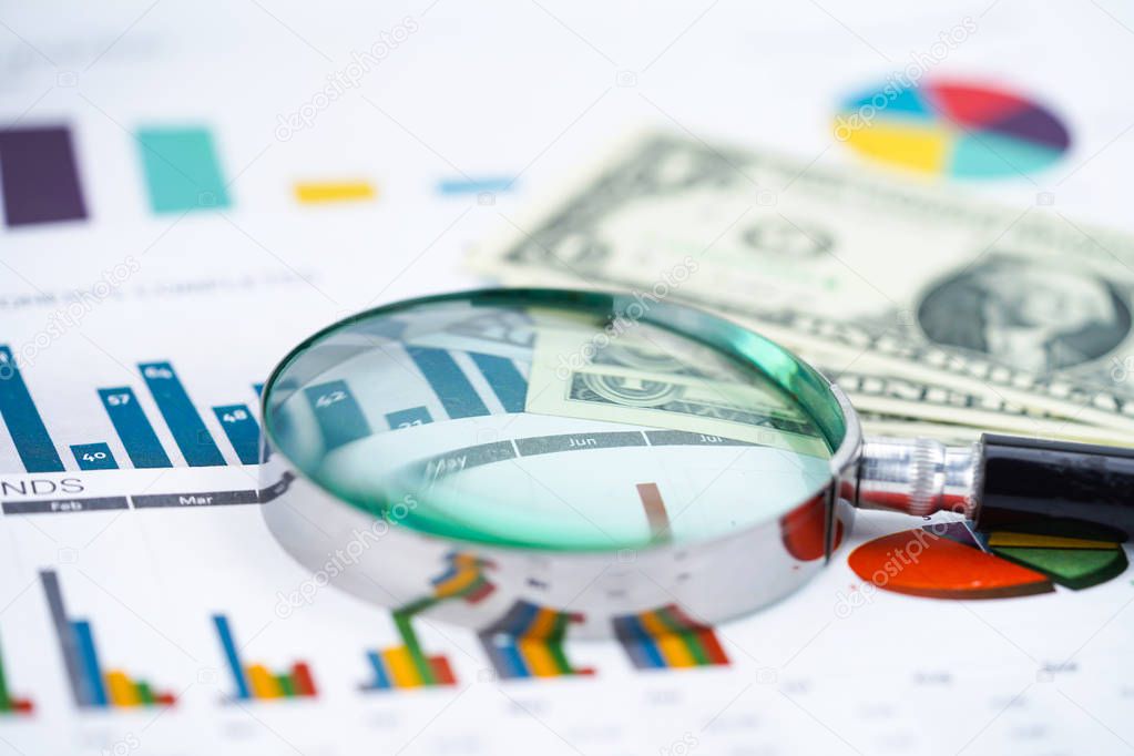 Magnifying glass on charts graphs spreadsheet paper. Financial development, Banking Account, Statistics, Investment Analytic research data economy, Stock exchange trading, Business office company meeting concept
