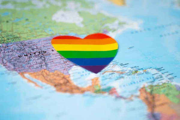 LGBT rainbow colorful heart on USA america globe world map background, symbol of lesbian, gay, bisexual, transgender, human rights, tolerance and peace.