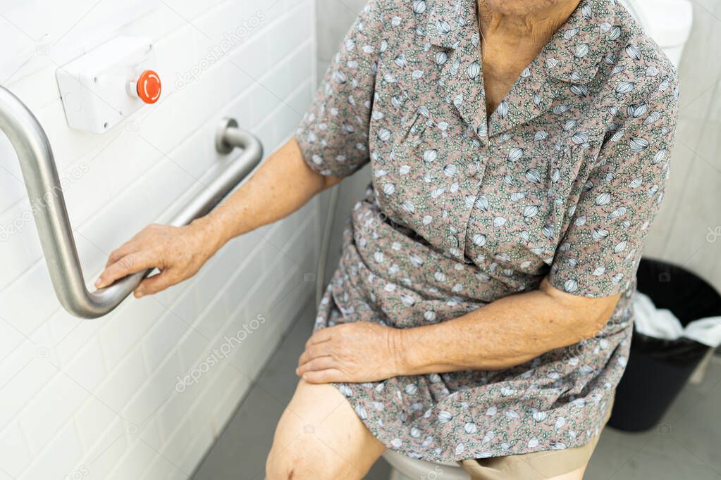 Asian senior or elderly old lady woman patient use toilet bathroom handle security in nursing hospital ward, healthy strong medical concept.  