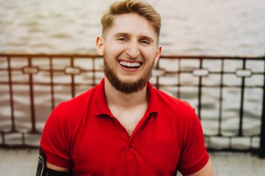 Gülümseyen ve kameraya bakarak sakal ile çalışan adam portresi kadar yakın.