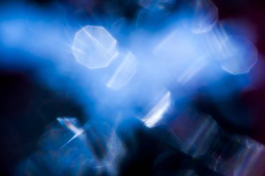 Göze batan azure bokeh arka plan üzerinde yumuşak odak karanlıkta parlar