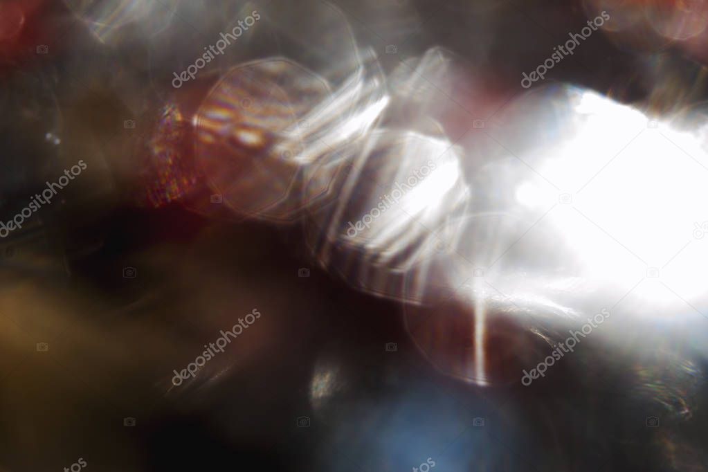 Abstract view of white shines in blackness on bokeh background