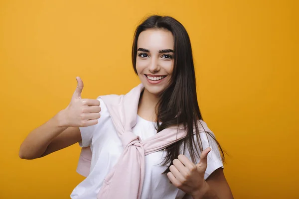 Smuk voksen brunette kvinde ser på kameraet og viser tha - Stock-foto