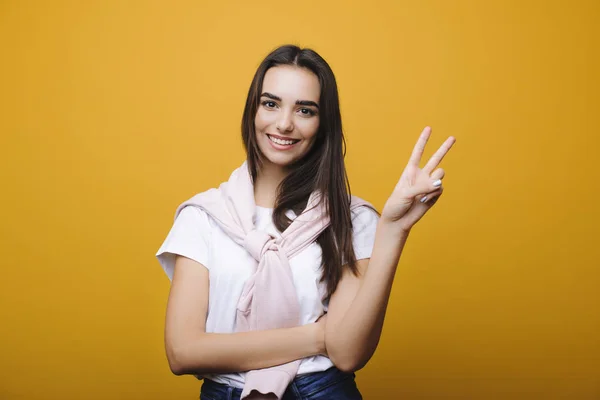 Schöne junge kaukasische Frau Blick auf Kamera und zeigt pe — Stockfoto