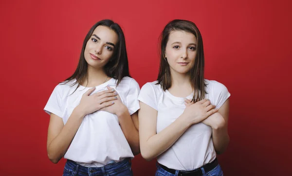 Portrait of a two beautiful female dressed in white shirts and j — Stock Photo, Image