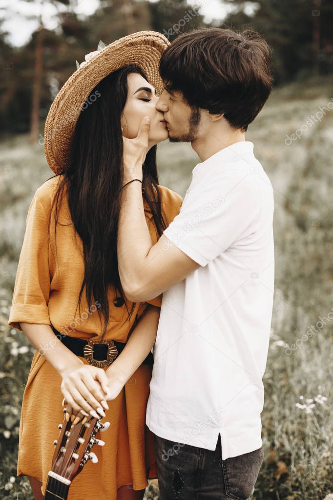 Side view portrait of a amazing couple kissing while man is touc