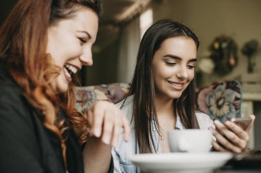 Bir akıllı telefon arayan koyu uzun saçlı lovely genç kadın 