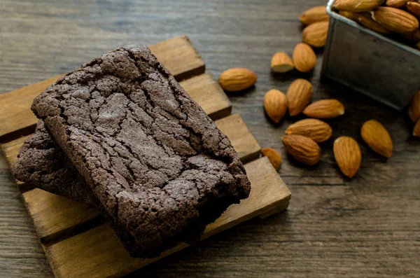 The Chocolate Brownie with Almonds and Coffee on the pallet wood has ready to served in the dessert time.