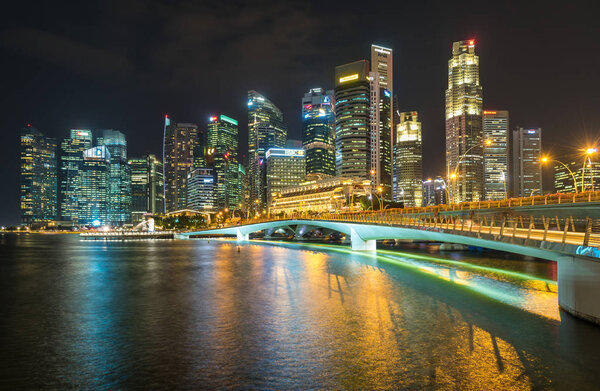 MARINA BAY SANDS, SINGAPORE - May 23, 2017: Colorful Singapore City skyline on the bridge at night Marina Bay Sands.