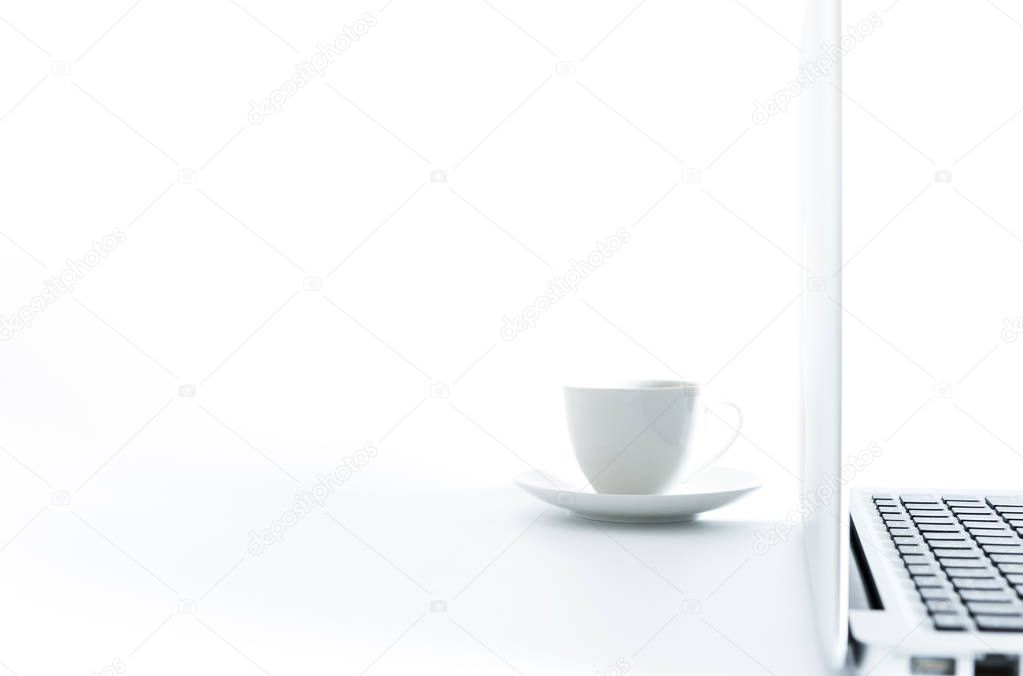 A cup of coffee and computer isolated on white background with working and business concept.