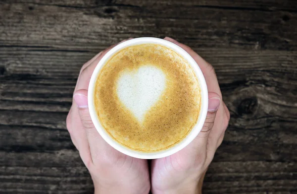 Man Holding Latte Coffee Art Heart Milk Isolated Brown Wood — Stock Photo, Image