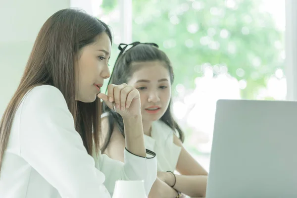 Women working together with intention and seriously in the office interior.