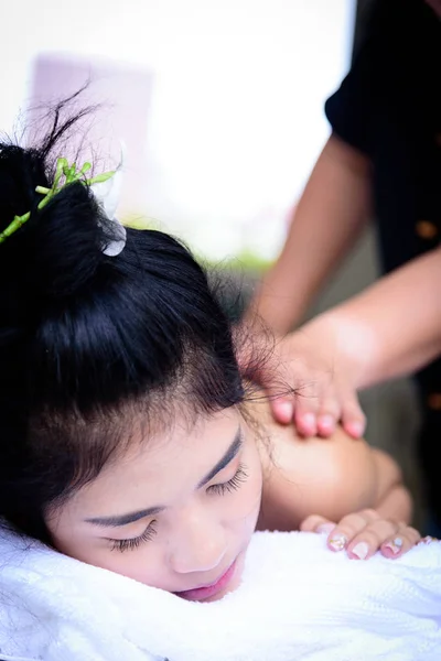 Portrait of beautiful asian people with close up view and close up eyes and having hand massage in spa salon. Beauty, healthy, spa and relaxation concept.