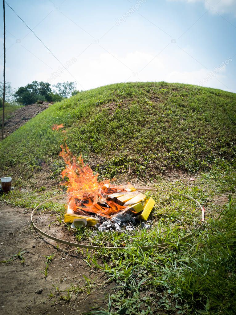 Paper and gold was burning in Qingming Festival or Tomb Sweeping day in Saraburi, Thailand.